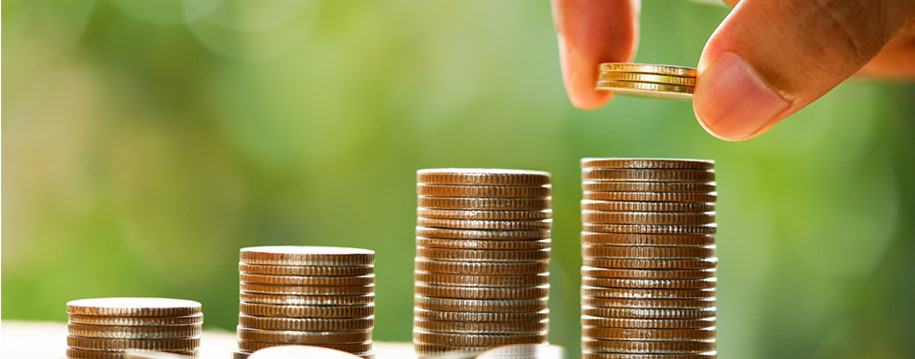 hand counting piles of coins